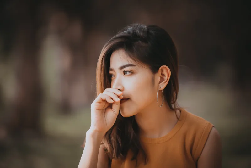 Woman with thoughtful expression showing emotional vulnerability central to maturity in relationships