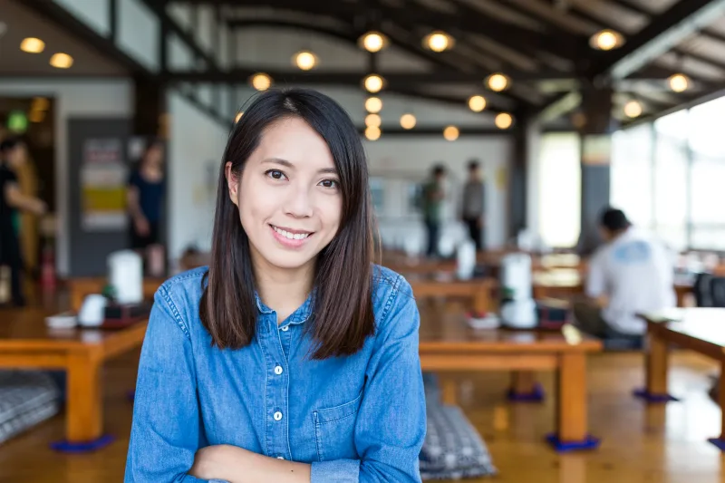 Young Filipina in casual setting smiling, representing importance of family integration in relationships