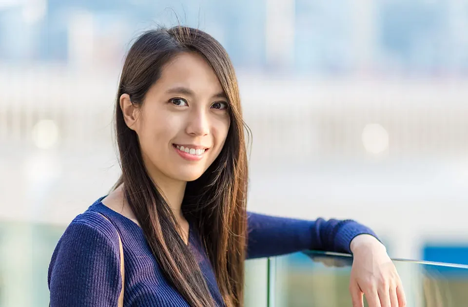 Smiling Filipina standing outdoors