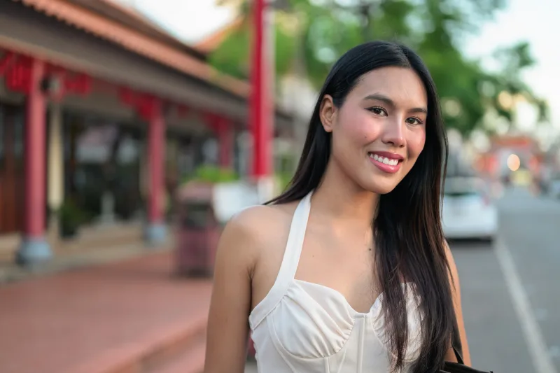Filipina woman in white dress outdoors, showing natural environment and genuine expression