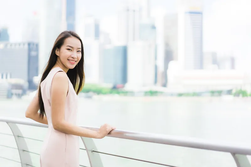 Woman in city setting appearing ready and confident, demonstrating concrete travel commitment to Filipina chat
