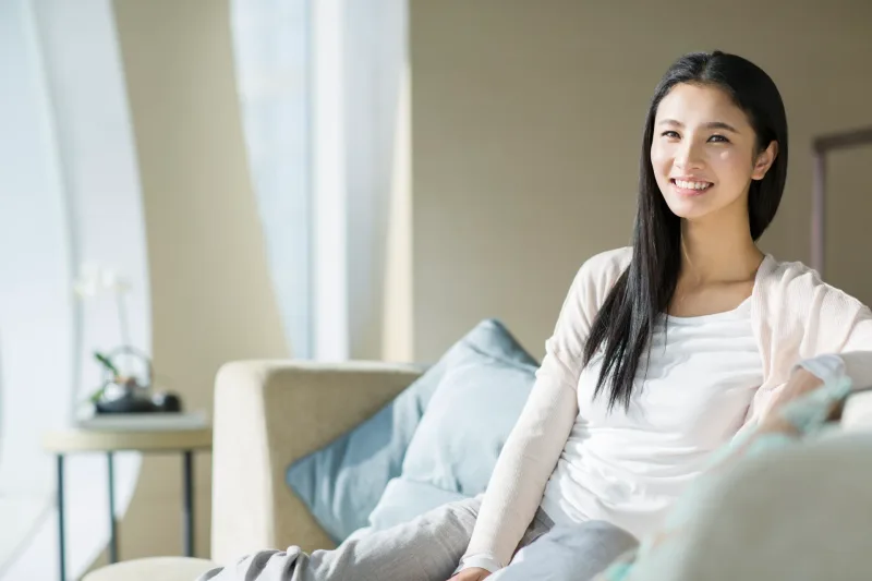 Relaxed Filipina woman at home in casual setting, embodying natural comfort and trust