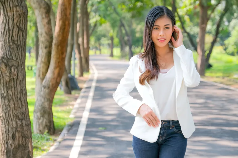 Professional filipina woman in white suit standing confidently