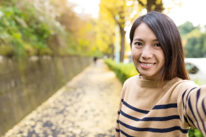 Smiling Filipina outdoors with natural confidence and warmth