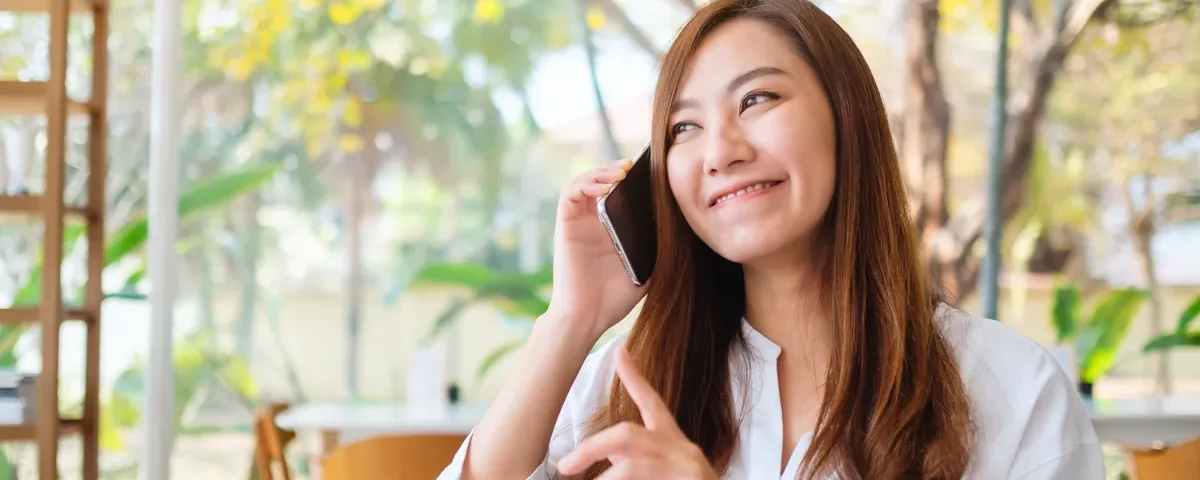 Filipina woman chatting happily on her mobile phone
