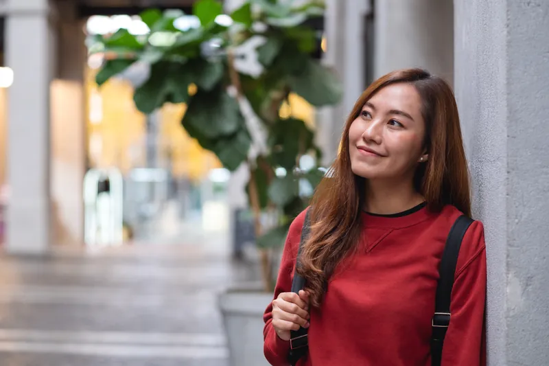 Woman walking on city streets with a genuine warm smile
