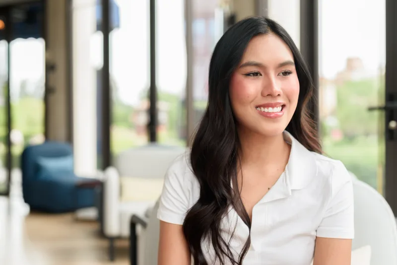 Approachable Filipina smiling indoors, reflecting the honesty needed in endgame conversations