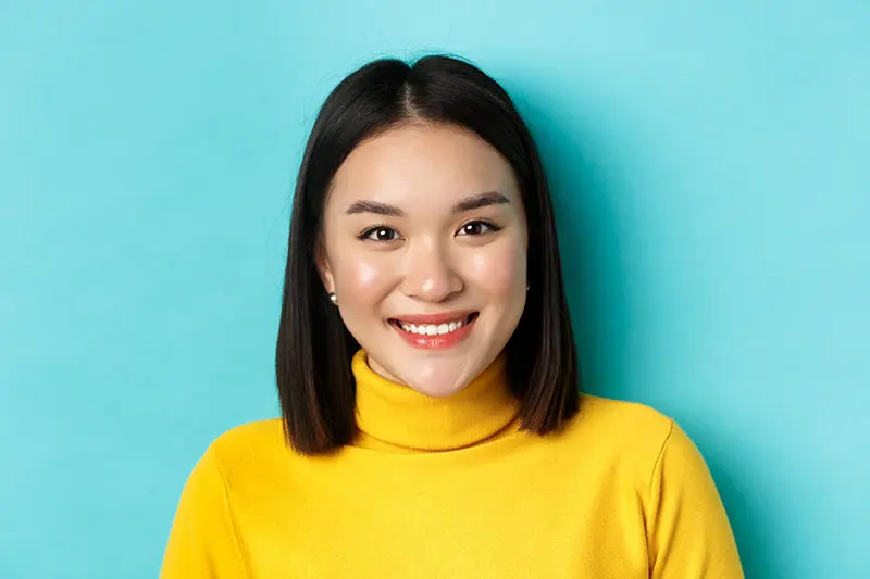 Close-up portrait of woman smiling warmly showing genuine connection and commitment signals