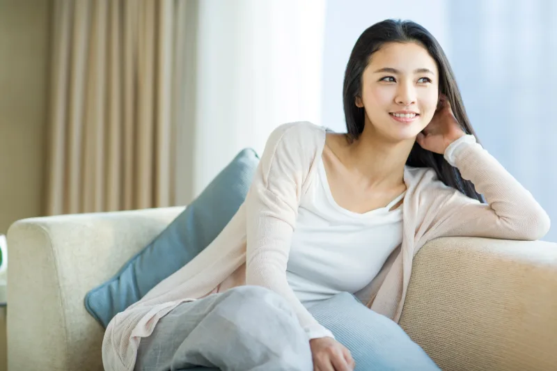 Woman in casual indoor setting, comfortable and approachable like those you'll meet in Davao's relaxed social spaces