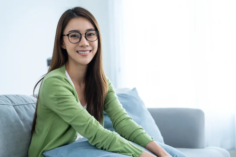 Friendly woman in glasses smiling at home, reflecting the authentic, genuine interactions valued in Davao