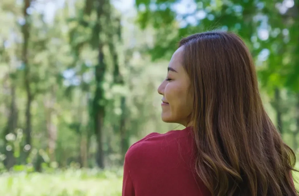 Woman in blue jacket gazing at mountain landscape during outdoor travel adventure