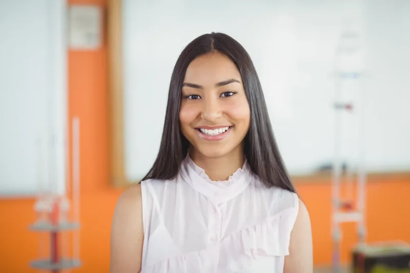 Professional woman smiling confidently in classroom setting