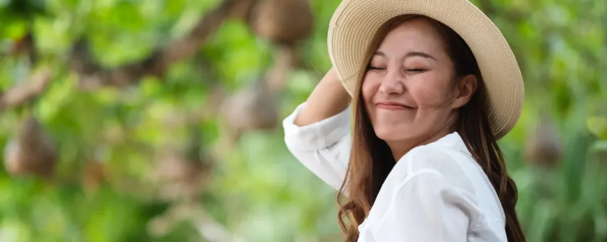 Asian woman in nature setting, peaceful expression