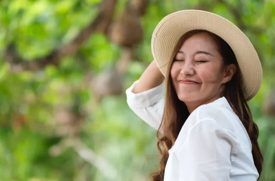 Asian woman in nature setting, peaceful expression