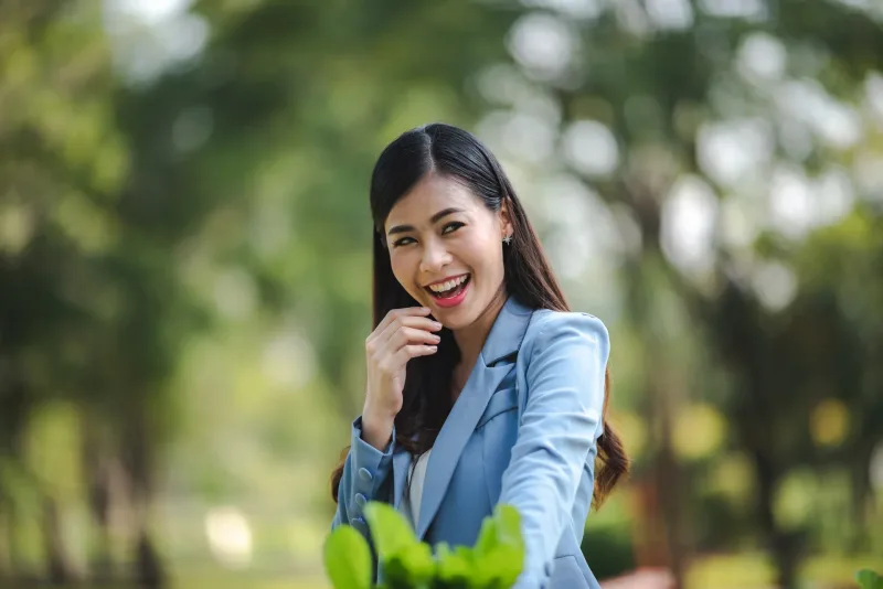 Woman smiling outdoors in urban park environment