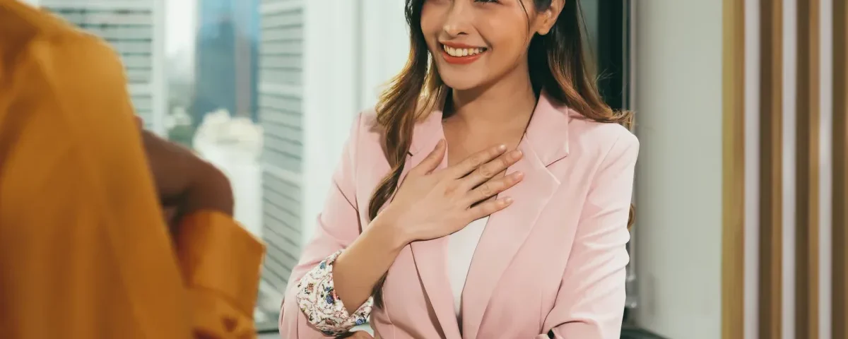 Smiling Asian woman with confident, genuine expression outdoors