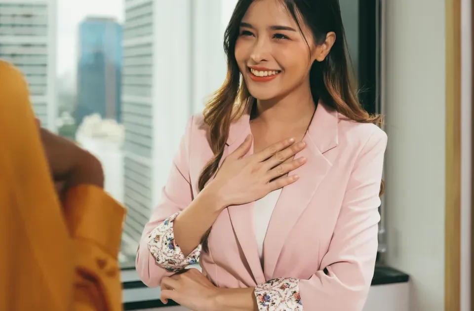 Smiling Asian woman with confident, genuine expression outdoors