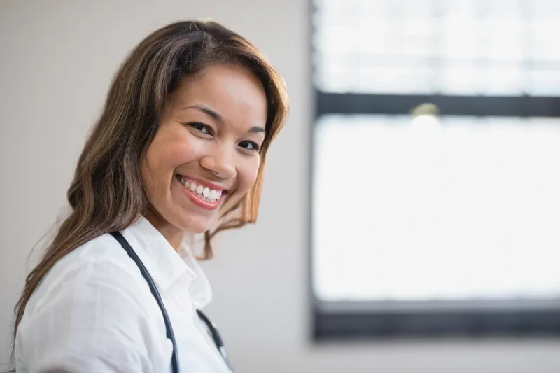 Professional Asian healthcare worker in confident pose with stethoscope