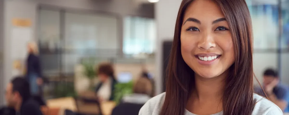 Woman in professional setting with confident smile