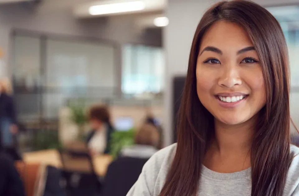 Woman in professional setting with confident smile