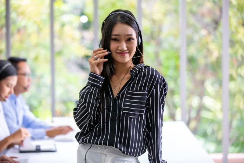 Professional woman at desk in office environment, confident demeanor