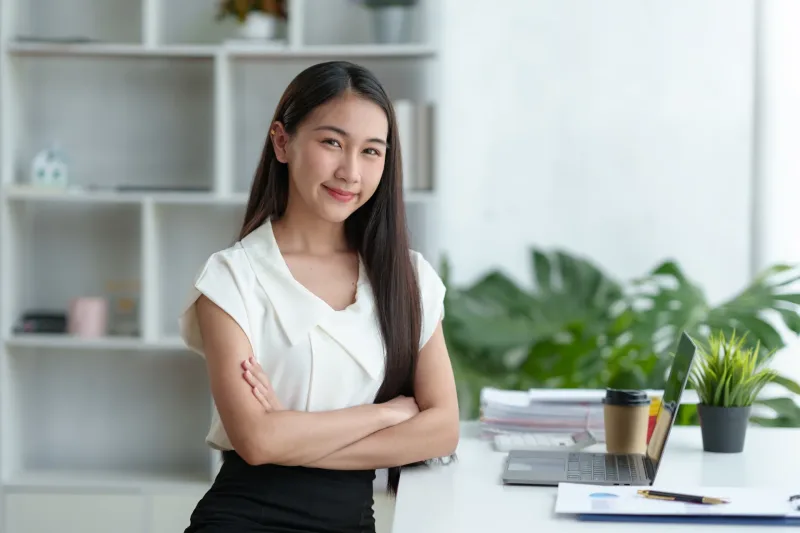 Confident Asian businesswoman smiling in professional office setting