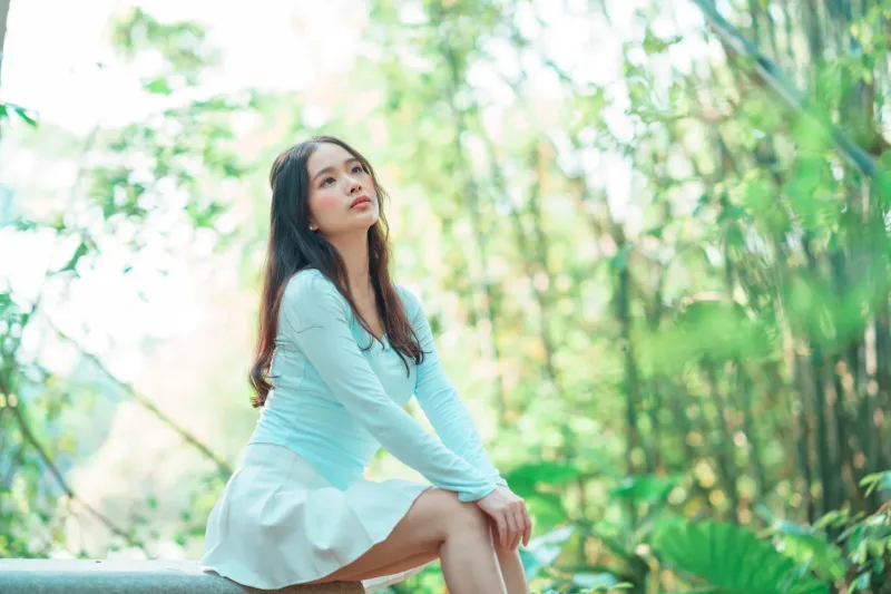 Composed woman in nature with a serene, contemplative expression