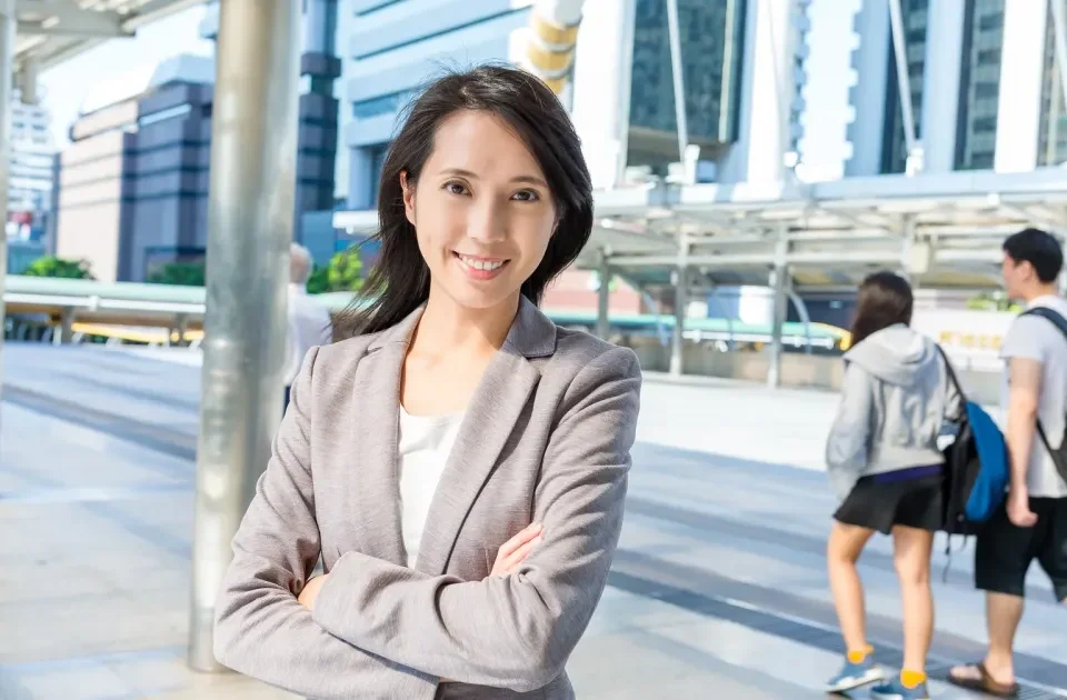 Woman smiling confidently in urban setting, embodying poise during engagement preparation