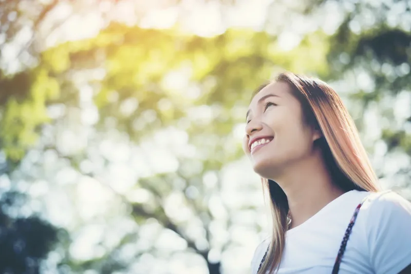 Woman in peaceful outdoor setting, symbolizing the calm during engagement period transitions