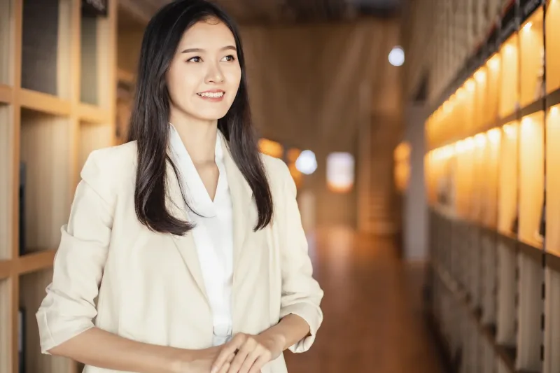Woman in office environment with professional lighting and confident expression