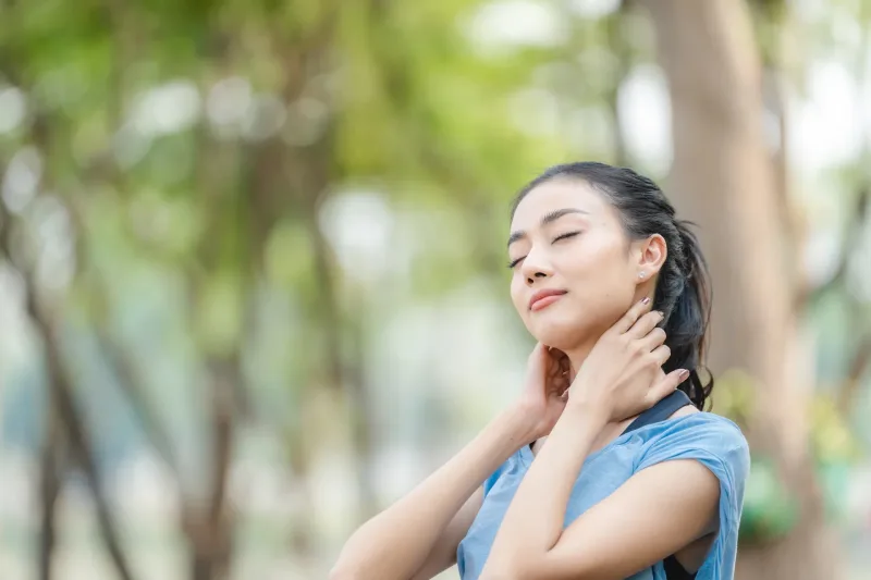 Woman serene in nature, embodying patience and consistent presence