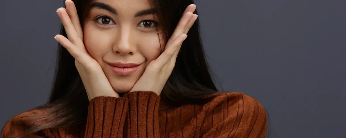 Woman with playful hand gestures expressing warmth and genuine interest