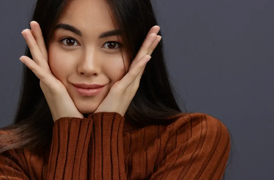 Woman with playful hand gestures expressing warmth and genuine interest