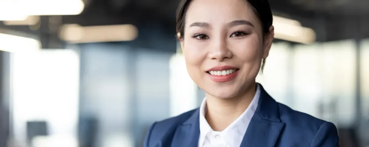 Professional woman smiling confidently, representing respectful first impressions