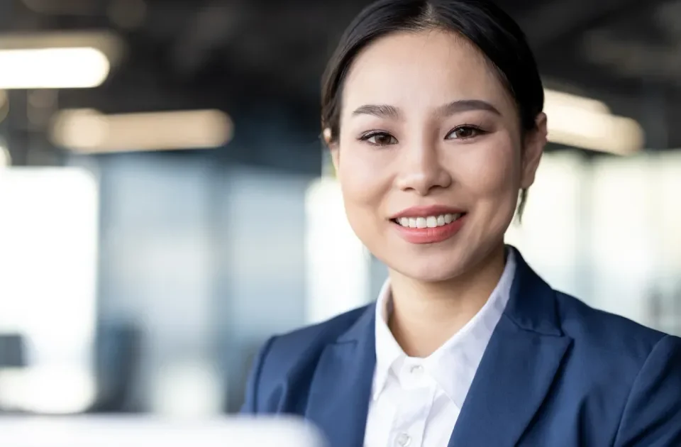 Professional woman smiling confidently, representing respectful first impressions