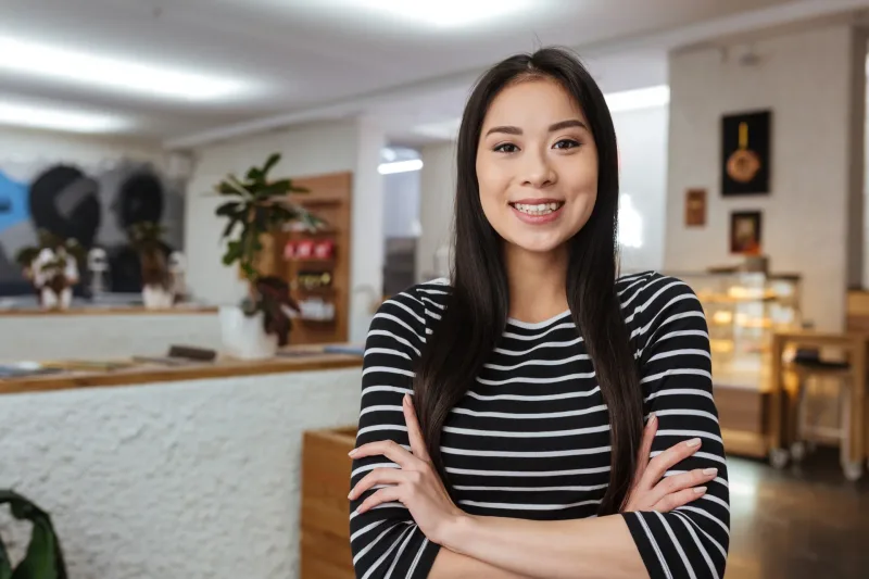Smiling woman in sweater with confident posture, embodying respectful presence