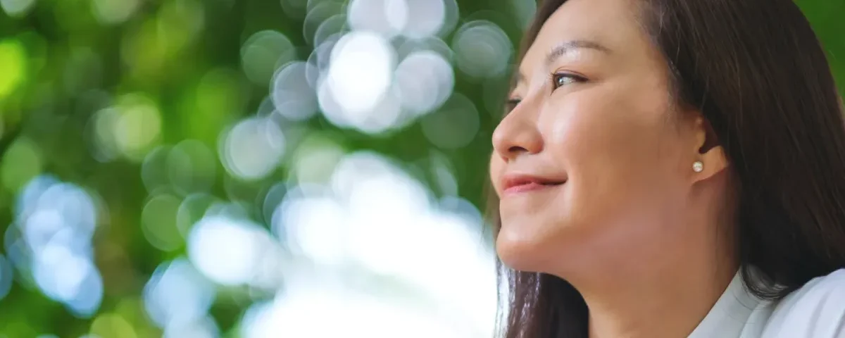 Young woman relaxing peacefully in nature, embodying calm presence