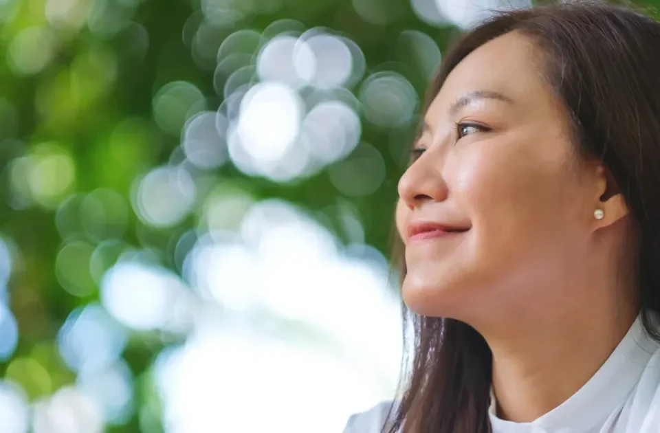 Young woman relaxing peacefully in nature, embodying calm presence