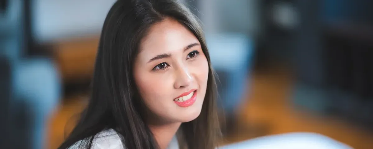 Confident woman smiling in professional portrait setting