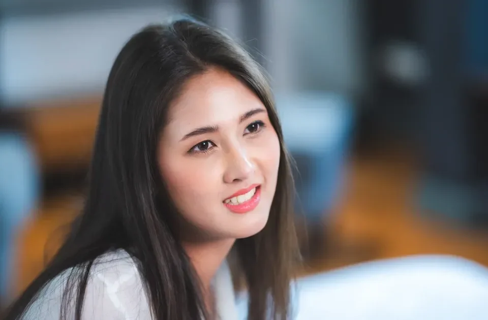 Confident woman smiling in professional portrait setting