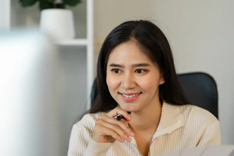 Woman engaged and attentive at her workspace, demonstrating focused interest