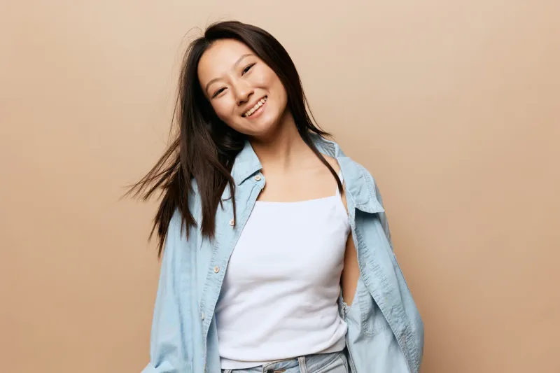 Woman in casual denim shirt with confident pose