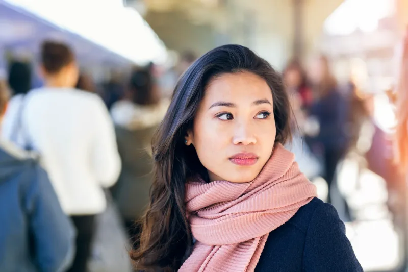 Young woman in thoughtful portrait, urban setting with natural light