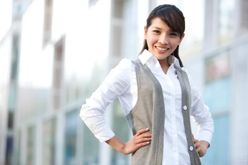 Woman in professional business-casual setting, reflecting official institutional contexts