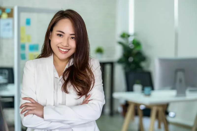Professional woman in office setting, representing formal workplace environments where English is standard