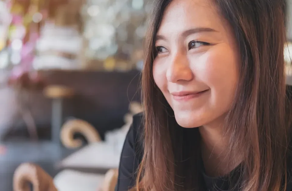 Woman smiling relaxed at cafe table