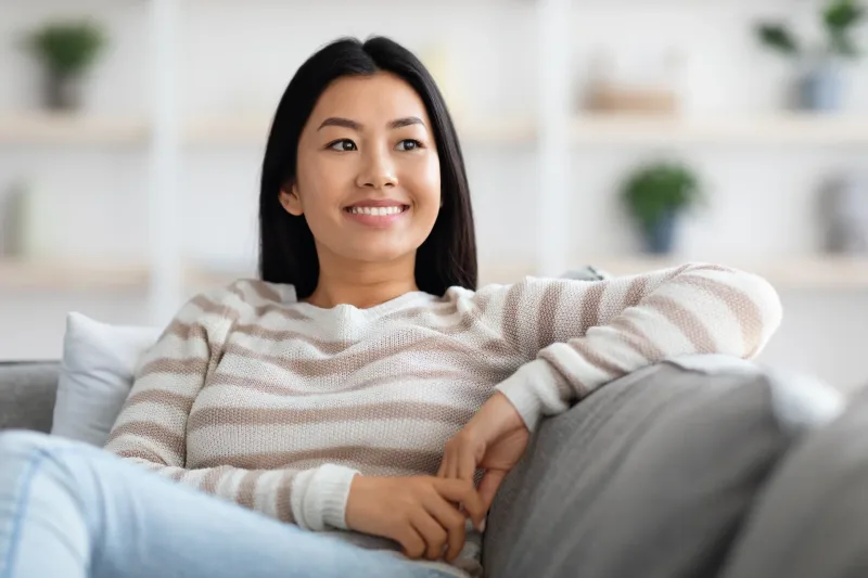 Woman relaxing comfortably on couch at home
