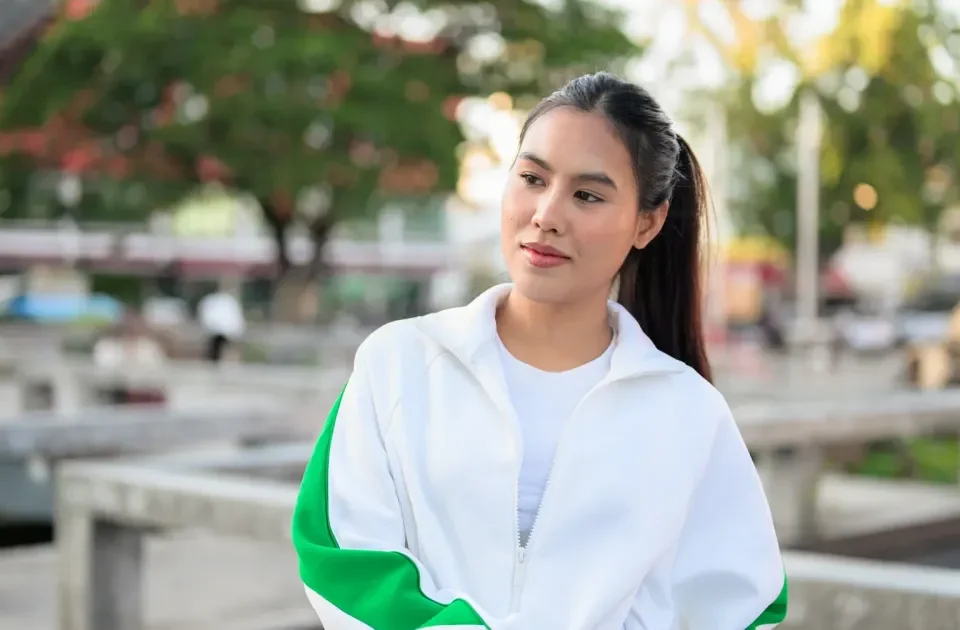 Woman in white tracksuit relaxing in urban park setting