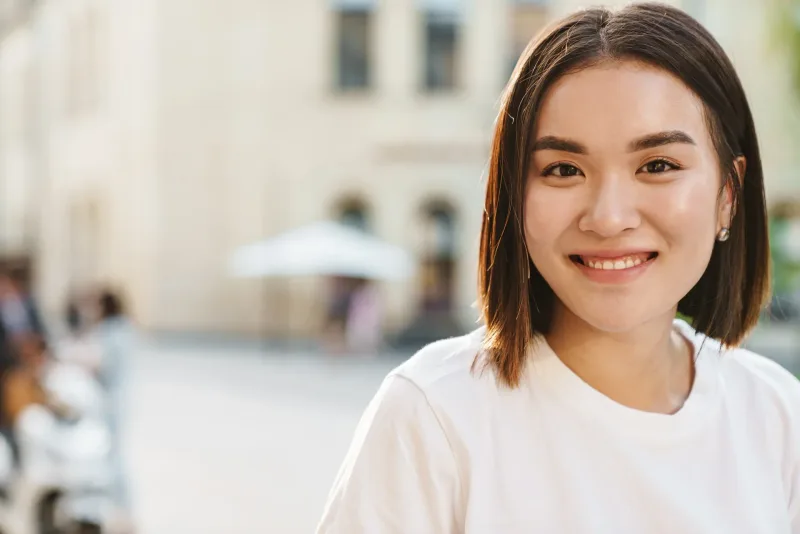 Close-up of smiling woman with friendly expression in natural light