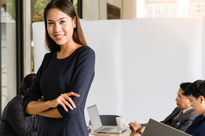 Woman relaxed in office setting holding warm beverage, representing comfort and trust in relationship context